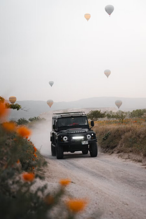 Jeep Surrounded by Hot Air Balloons